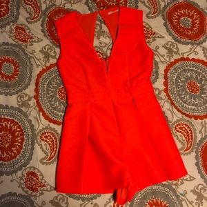 Flirty orange romper. Never worn.